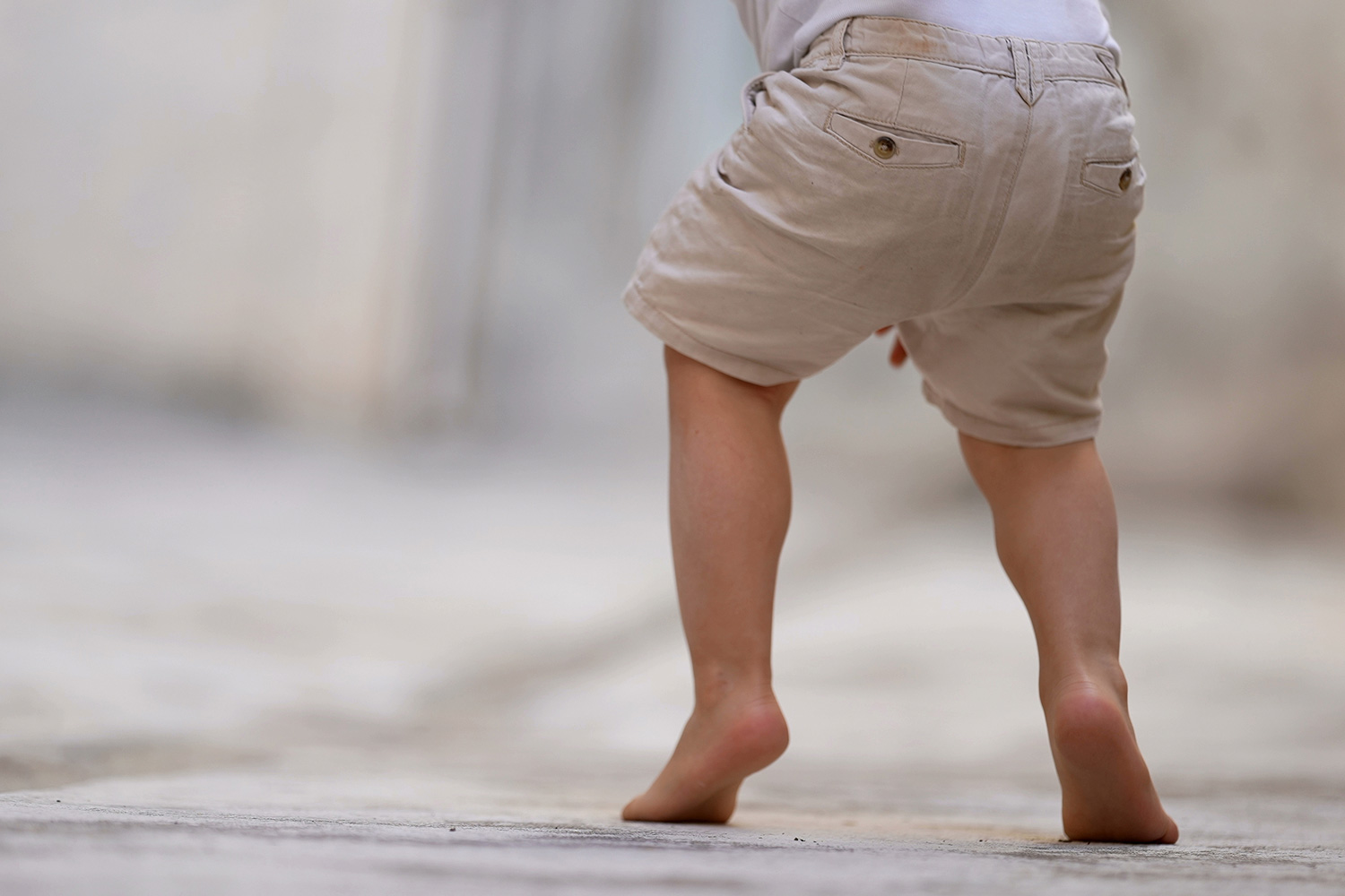 Toddler walking on his toes